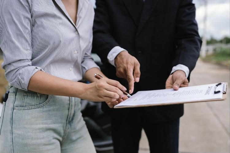 An advisor walking a client through a document before she signs